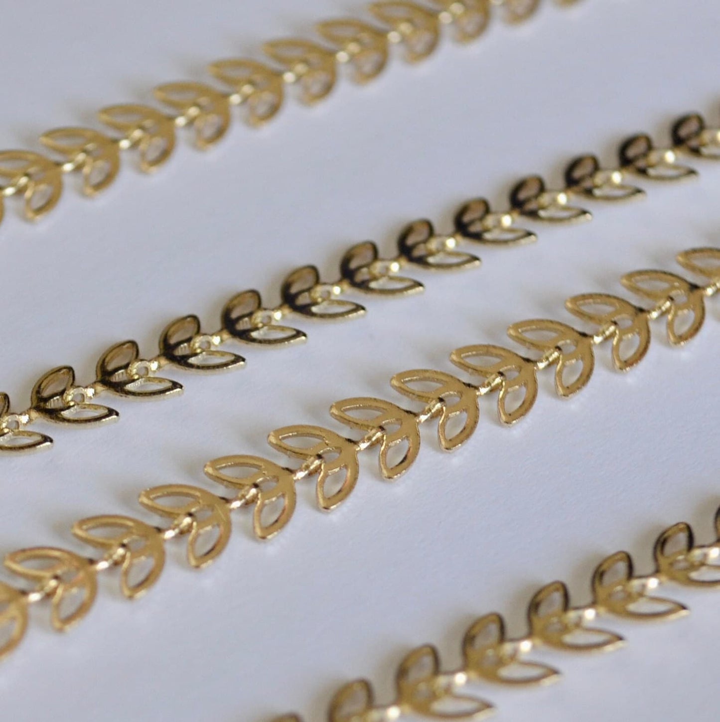 Gold filled chain decorative border strips on a white background