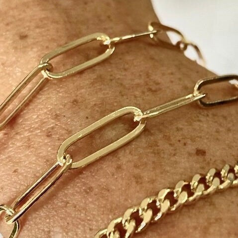 Gold chain bracelet on a person