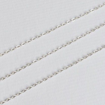 Silver cable chain on a light gray background