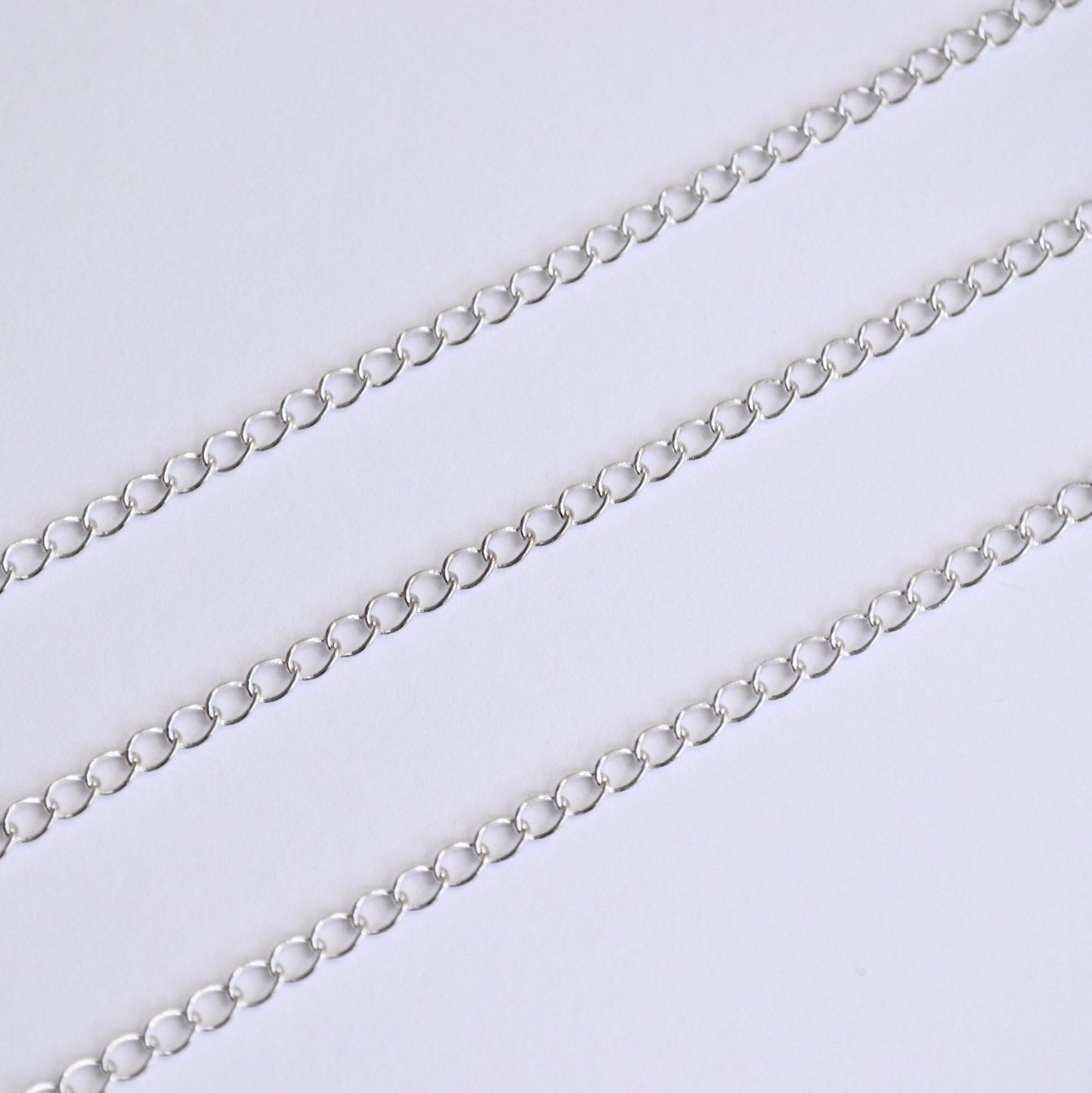 Silver extender chain on a light gray background