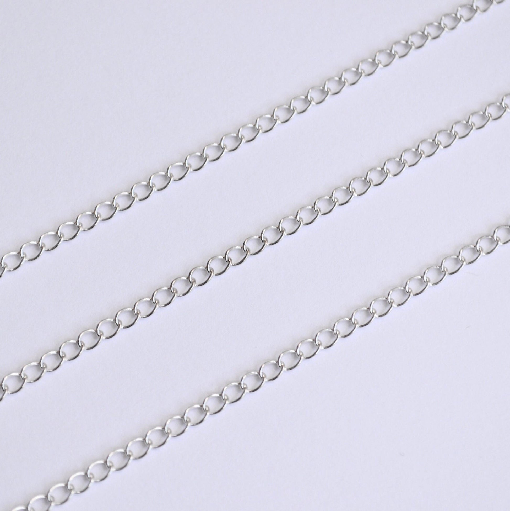 Silver extender chain on a light gray background