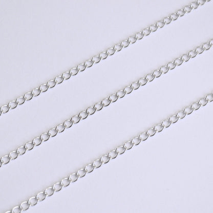 Silver extender chain on a light gray background