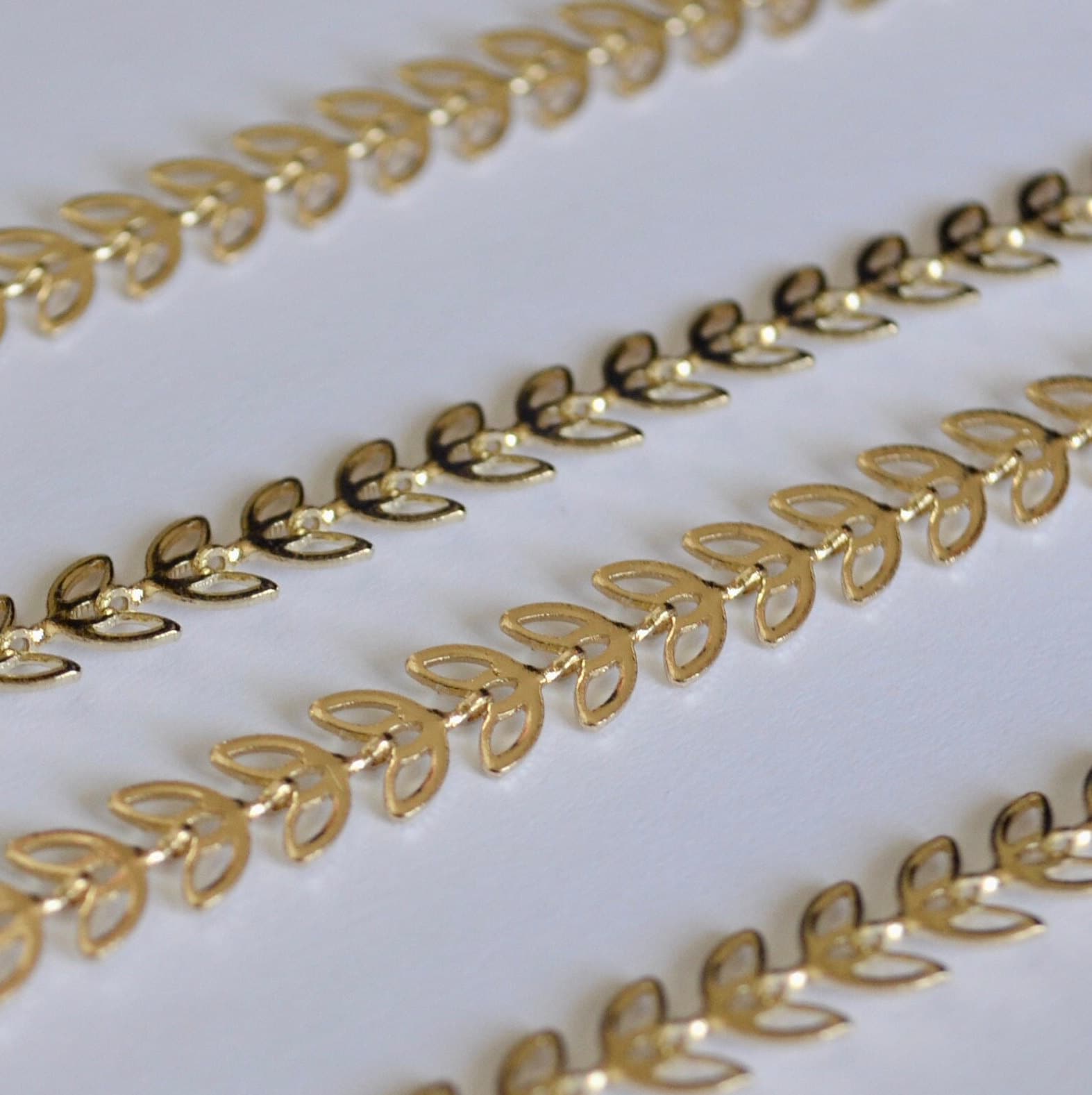 Gold filled chain decorative border strips on a white background
