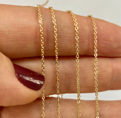 Tiny gold filled cable chain of a hand 