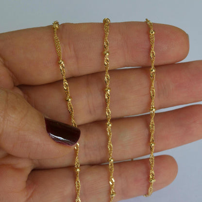 Close-up detail of 14k gold filled dainty satellite chain showing link texture