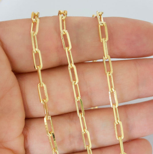 14k Gold filled paperclip chain held between fingers against a white background