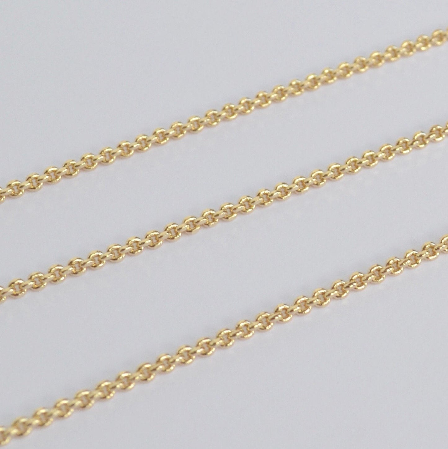 Gold filled thick chain on a light gray background