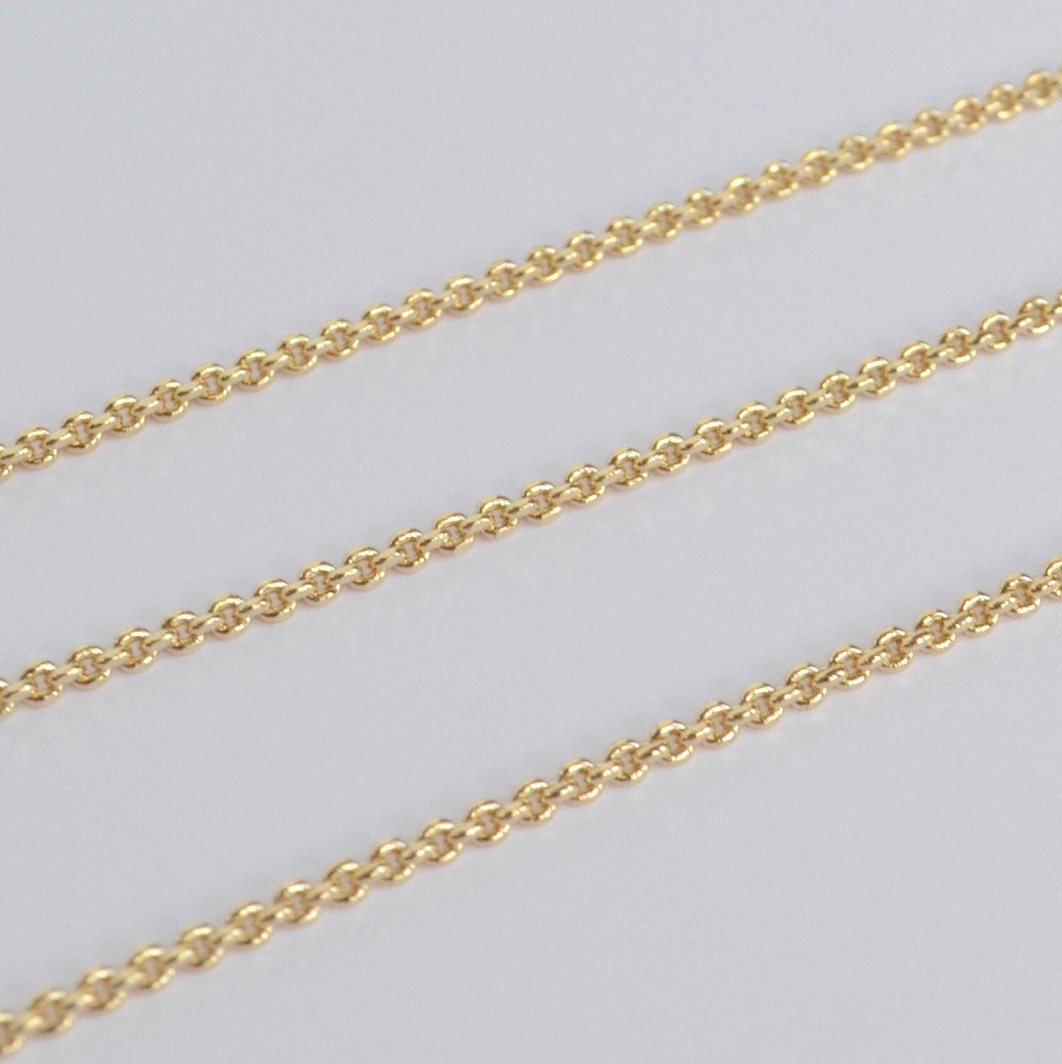 Gold filled thick chain on a light gray background