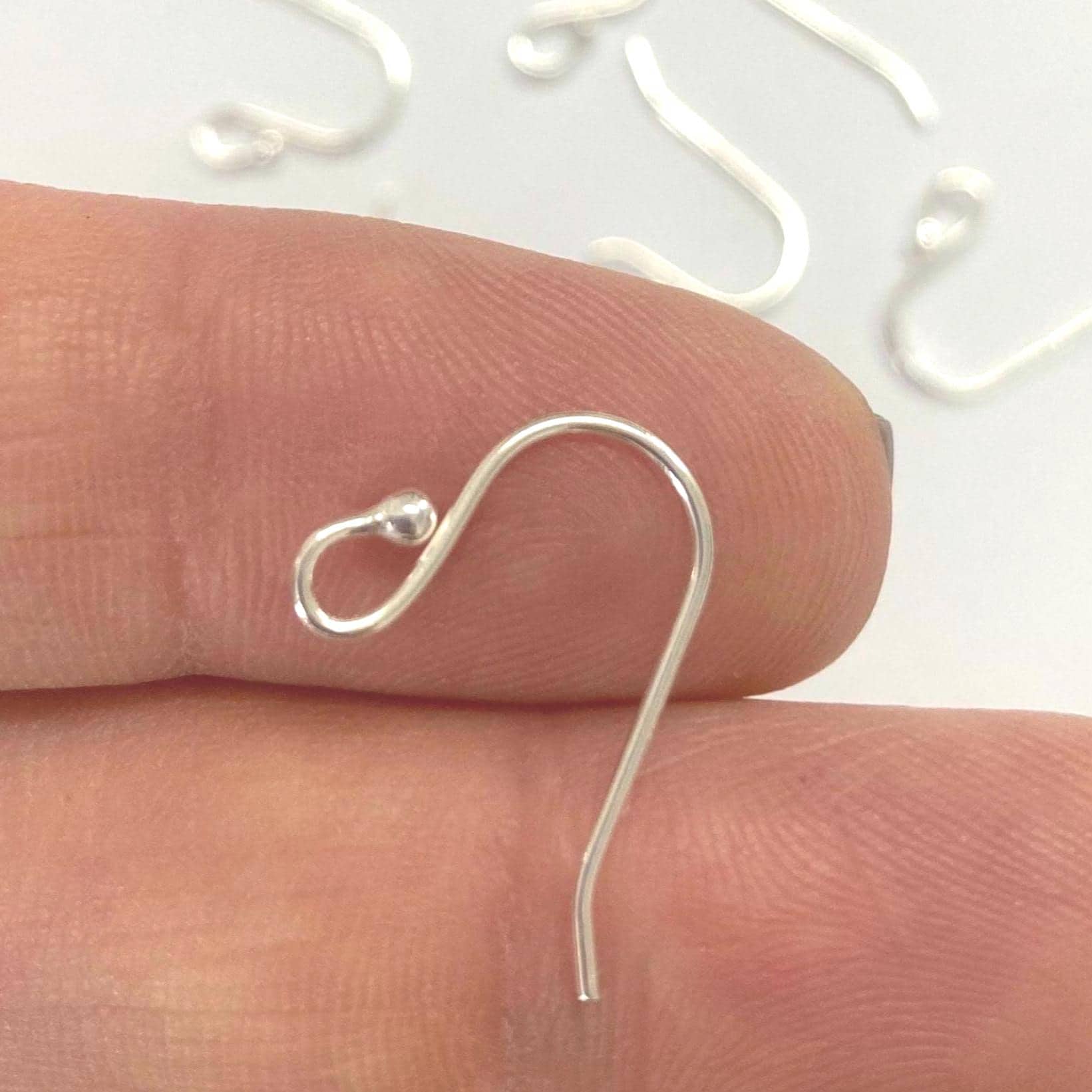 Sterling Silver earring hook on a finger with a white background