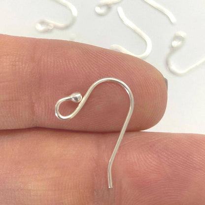 Sterling Silver earring hook on a finger with a white background