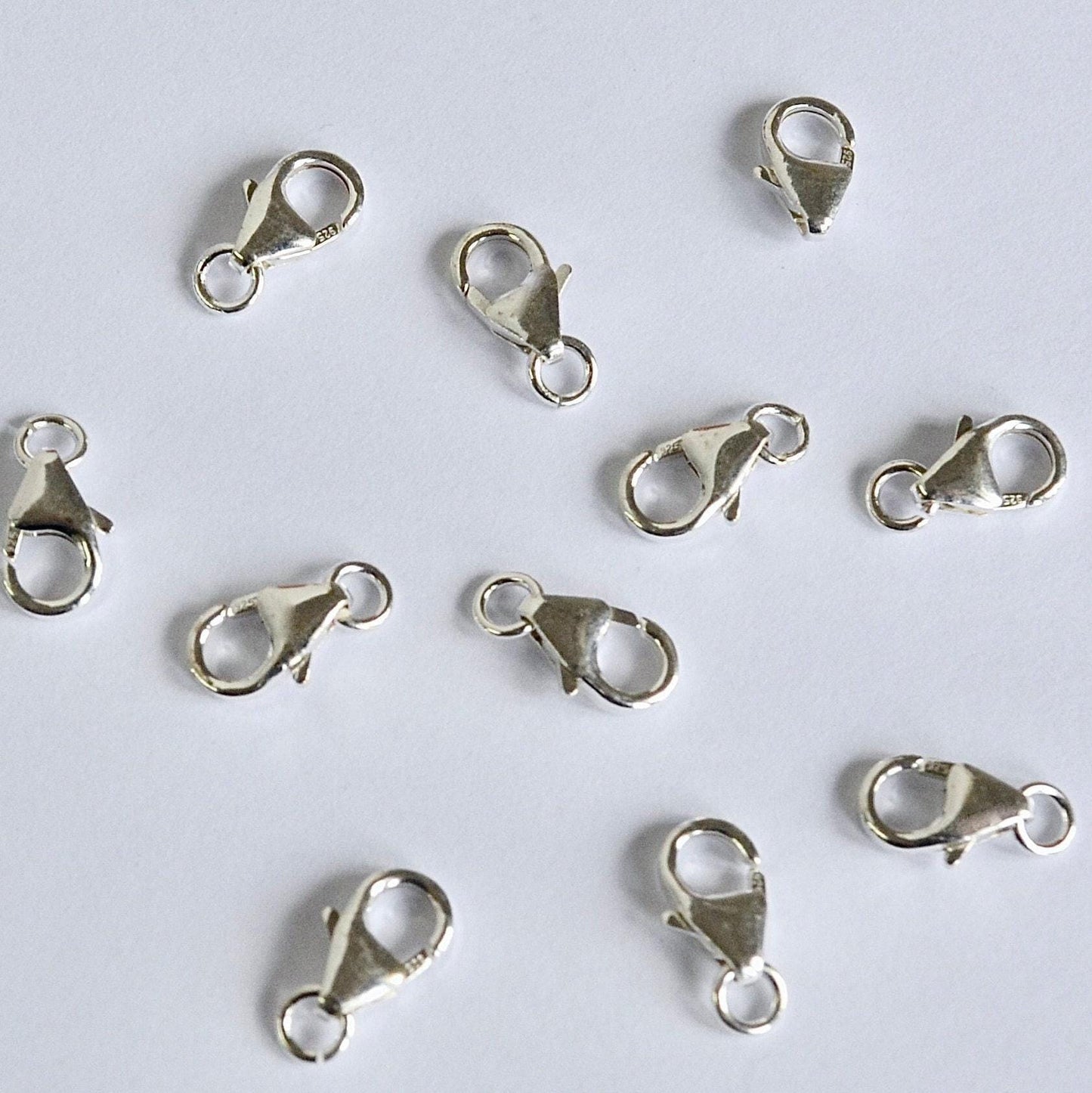 Silver lobster clasps on a white background
