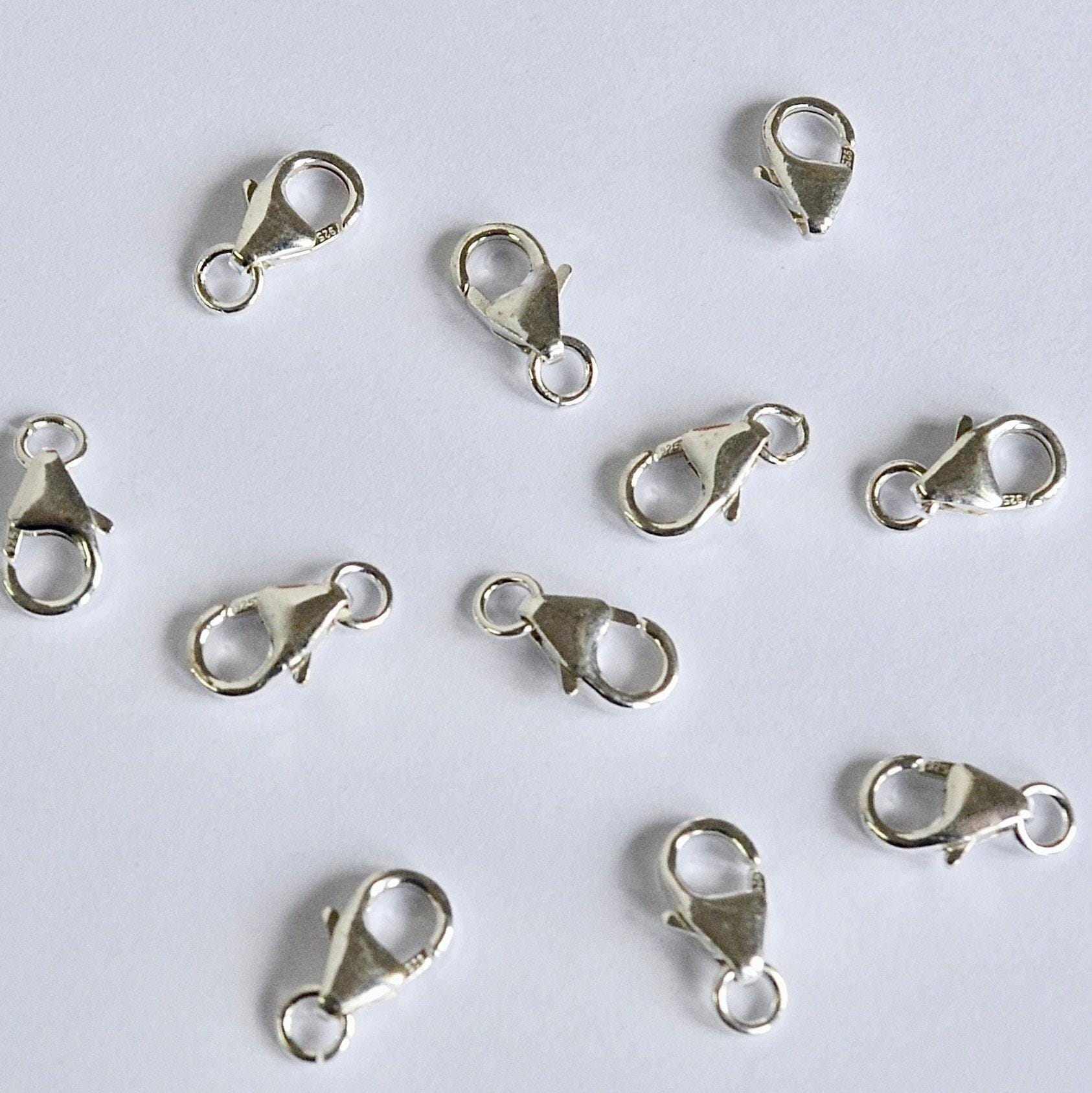 Silver lobster clasps on a white background