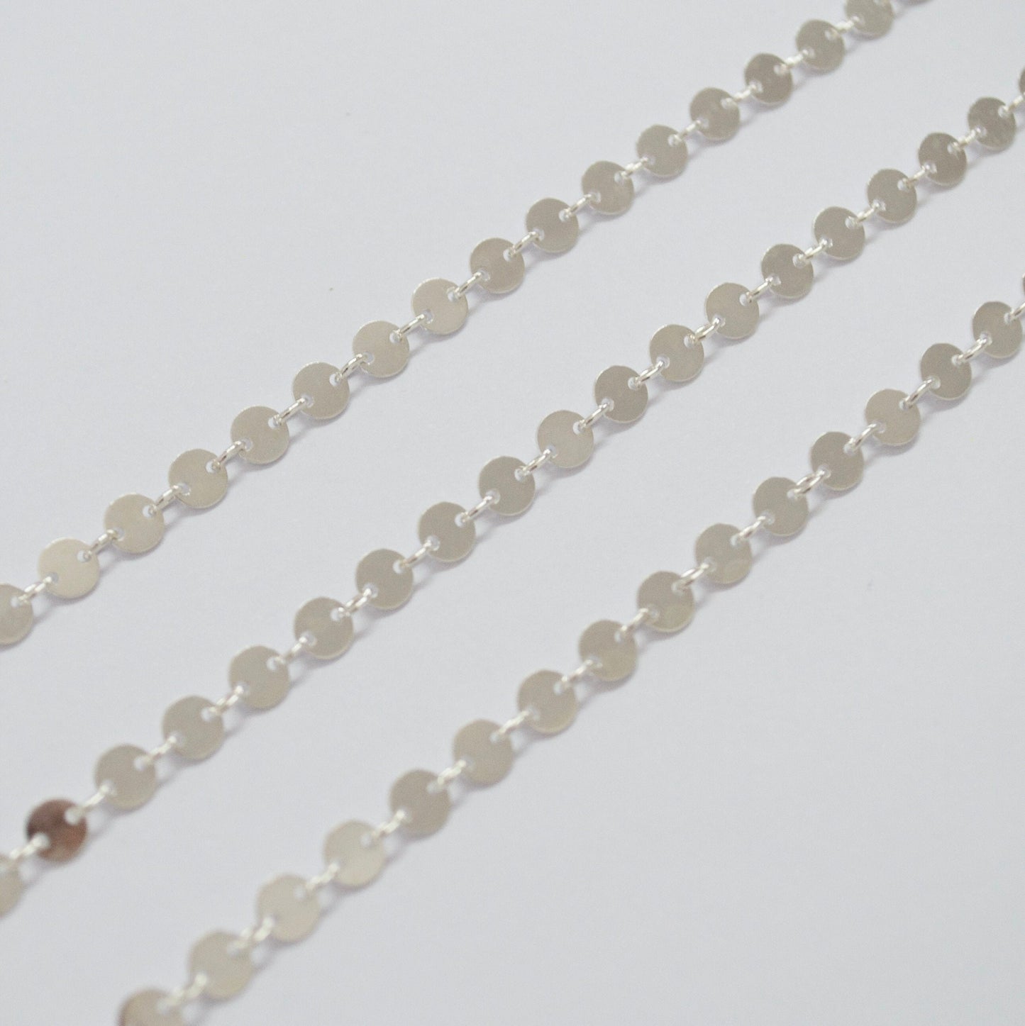 925 Sterling Silver coin chain on a white background