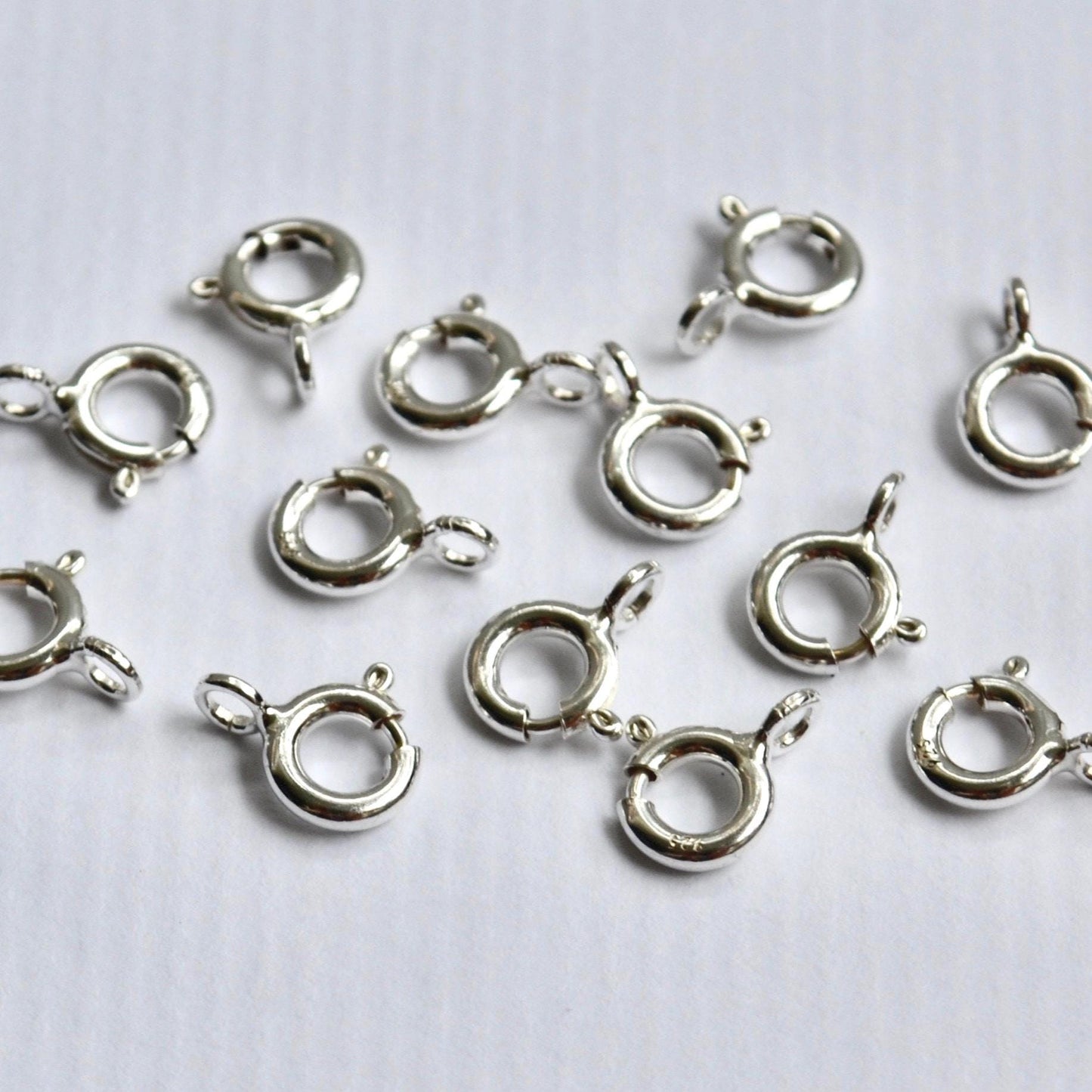 Sterling Silver ring clasp connectors on a white background