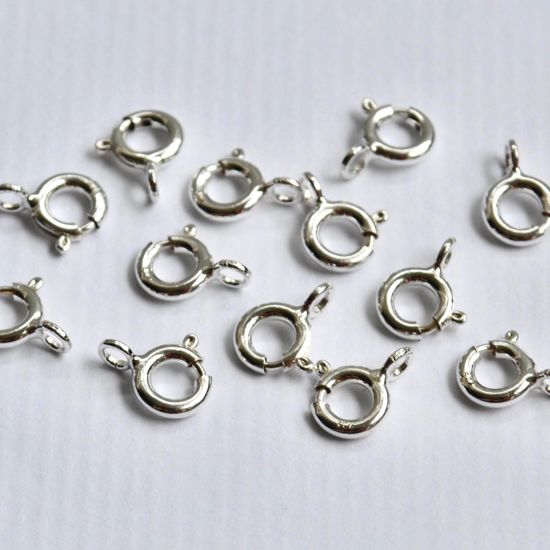 Sterling Silver ring clasp connectors on a white background