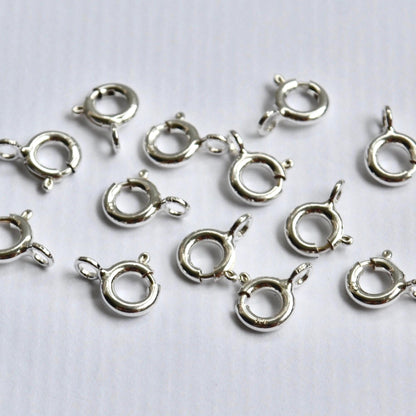 Sterling Silver ring clasp connectors on a white background