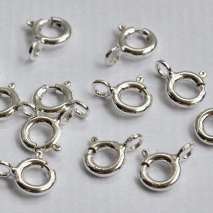 925 sterling Silver spring clasp components on a light gray background